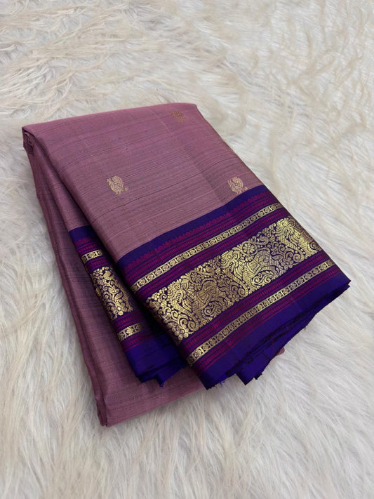 Dusty Mauve Handwoven Pure Silk Kanchipuram Butta Saree with Royal Blue Border photographed folded to show the body colour, motifs, and border details.