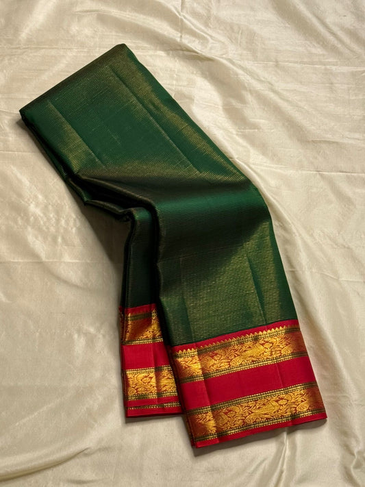 Kavi ✨ – bottle green vairaoosi 
Listeous  Green Silk Body vairaoosi 
Rich red Contrast Border in Gold Zari
Grand Pallu with Intricate Kili (Parrot) Motifs
Red Blouse with Matching Zari Border Silk Mark Certified, delivery in 2 weeks