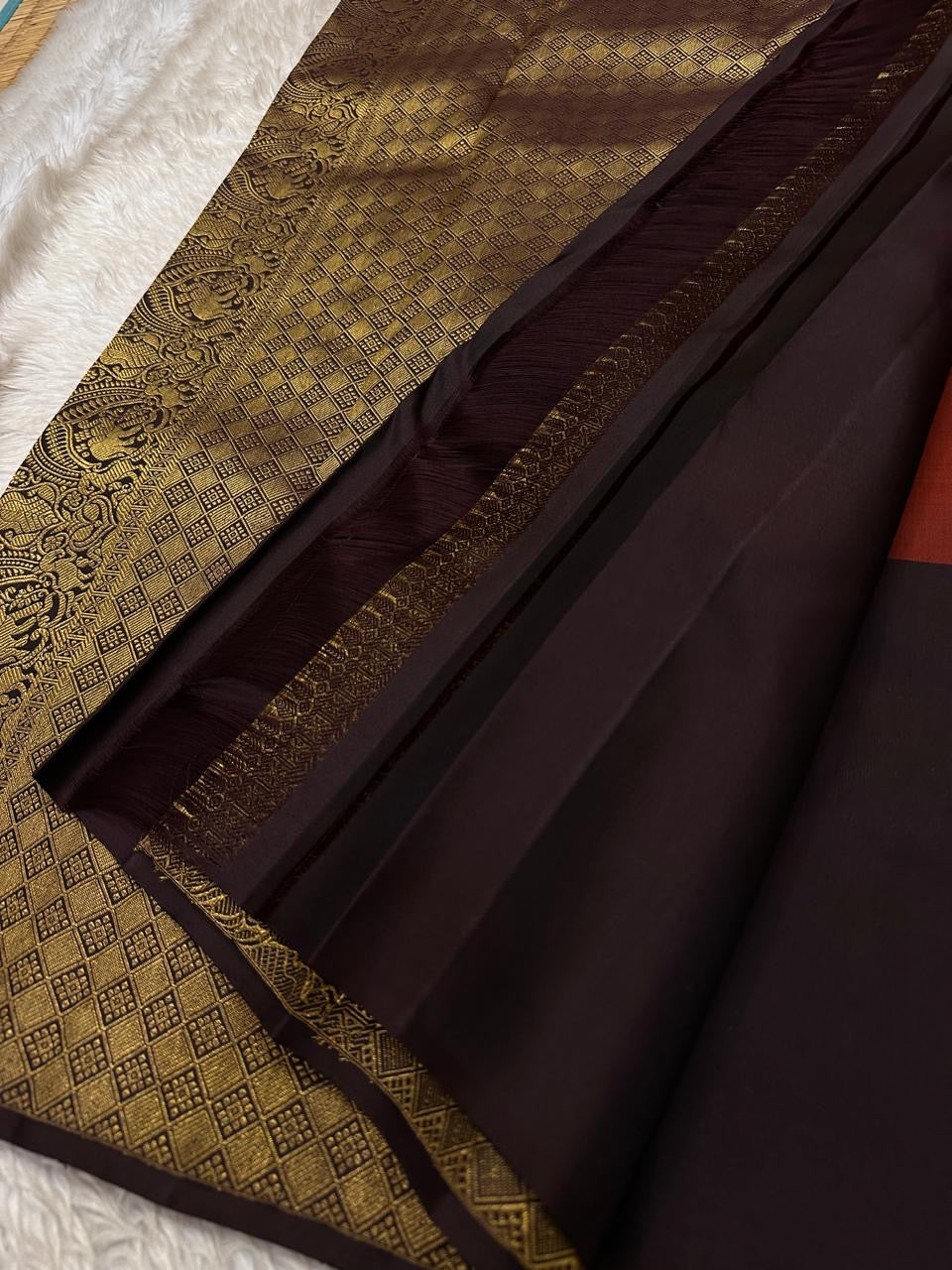 Sudar Mayil – Radiant Burnt Orange Pure Kanchipuram Silk Saree
Lustrous burnt orange body adorned with intricate gold vine jaal.
Broad deep plum borders gleam with antique zari artistry.

Silk Mark Certified, delivery in 2 weeks