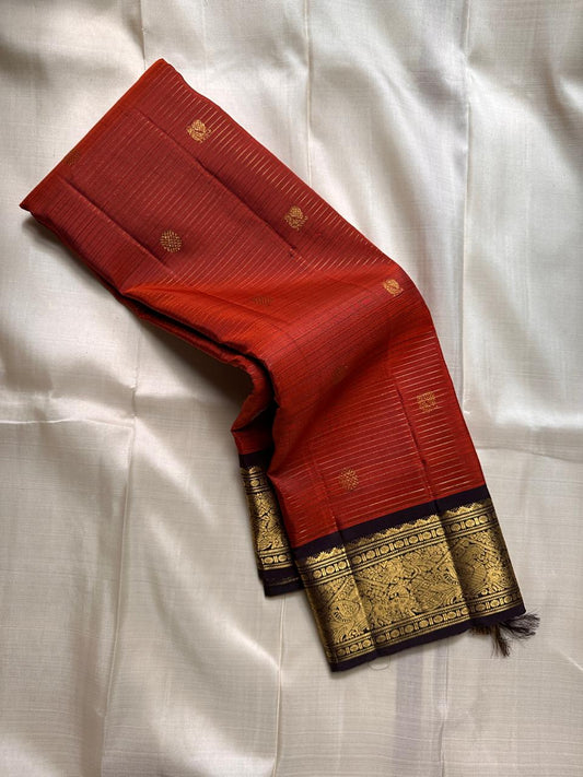 Amber Plume – Pure Kanchipuram Silk Saree
Amber Burnt-Orange Body with Vaira Oosi Stripes
Rudhraksham & Mayil Zari Woven Buttas All Over
Contrast Coffee-Brown Border with Peacock Motif Panel

Silk Mark Certified, delivery in 2 weeks
