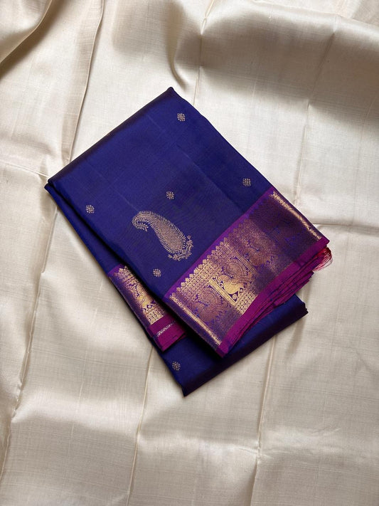 Pure silk violet shot with ink blue with zari kamalam butta and purple border with peacock motifs . Richly adorned Pallu with rudhraksh and kolam motifs