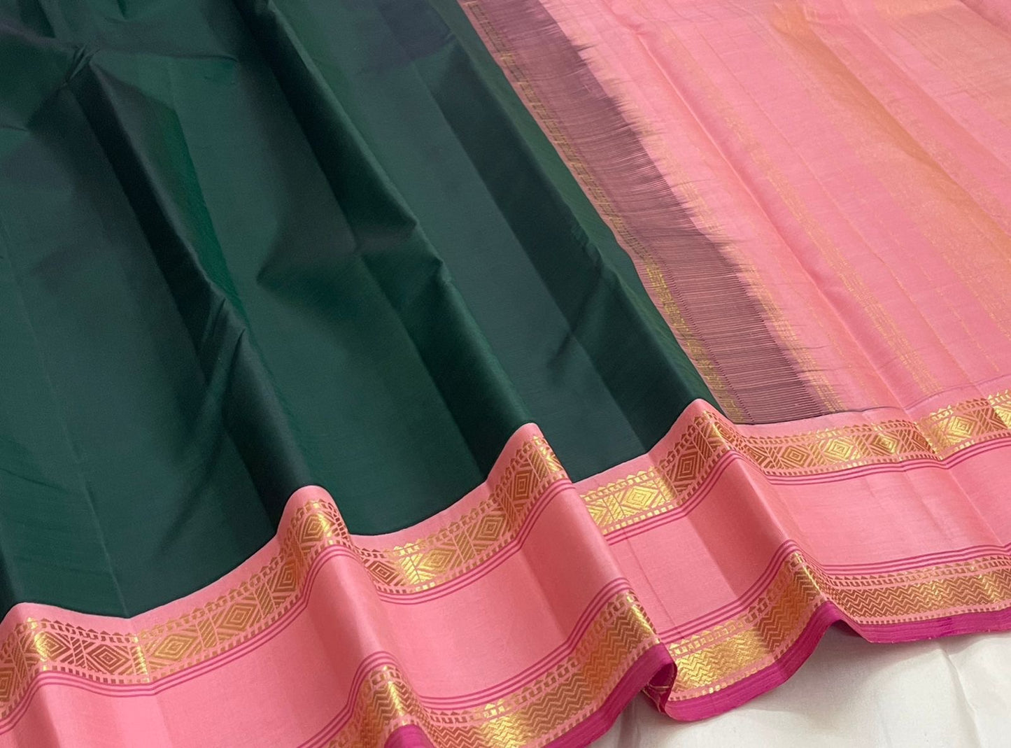 Draped view of Adar pachai green Kanchipuram silk saree highlighting thamarai pink rettapet border, shipped from New Jersey USA