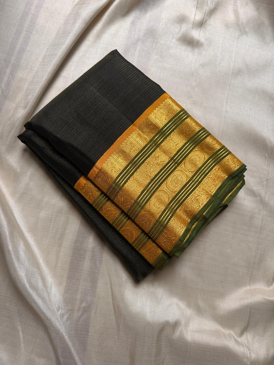 Darkest green with a vibrant vairaoosi and varisaipet border in ochre yellow and green