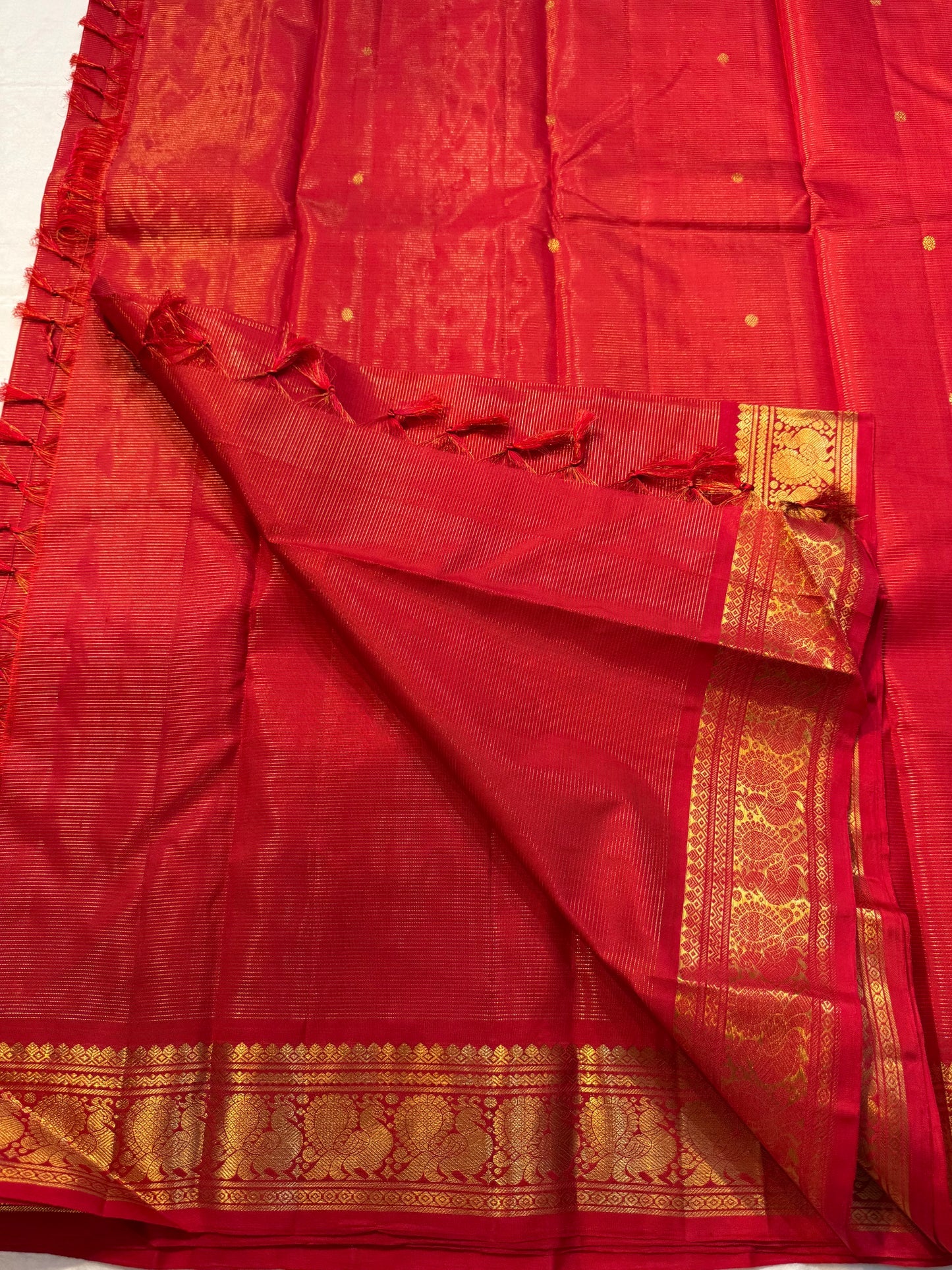 Vermillion Swarna Vairaoosi — Pure Kanchipuram Silk Saree
Vermillion red body with fine vairaoosi stripes, gold rosette buttas, and Gandaberunda borders in antique zari.
Silk Mark Certified • Free Shipping within USA • 2 weeks