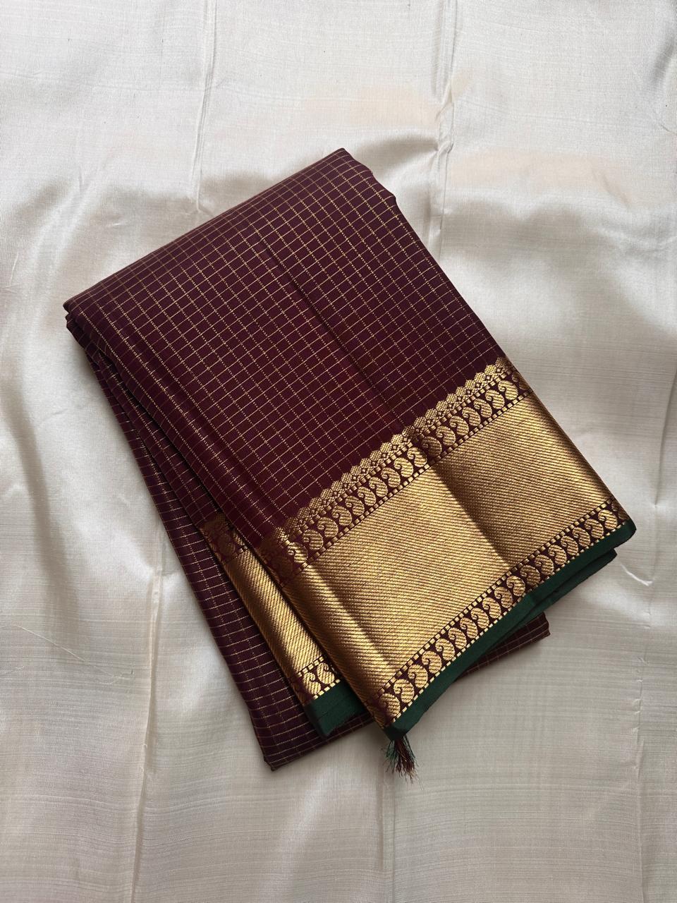 Kapi Ratna Kattam
Coffee-Deep Brown Zari Grid Saree
Pure Kanchipuram Handloom • Temple Gold Borders