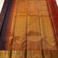 Deep Plum Orange
A regal dance of plum and burnt orange
Micro-checks kissed with golden buttas
Elephant borders marching in heritage grandeur
Brocade pallu glowing in timeless zari brilliance

Silk Mark Certified, delivery in 2 weeks
