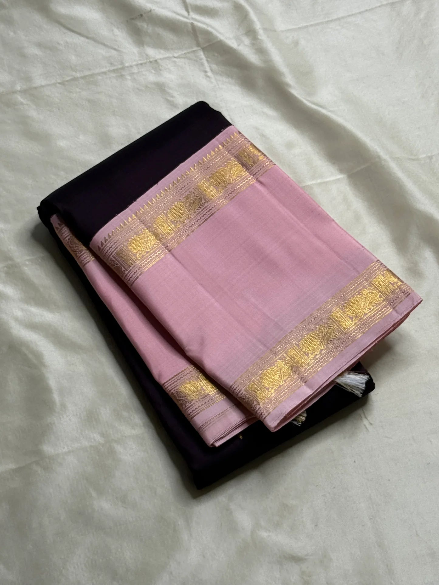 Rose Twilight – Pure Kanchipuram Silk Saree
Pastel Rose-Pink border with Golden Zari Weaves
Deep Plum-Violet Base Scattered with Gold Buttas
French Rose Rettapet Border in Lustrous Zari

Silk Mark Certified, delivery in 2 weeks