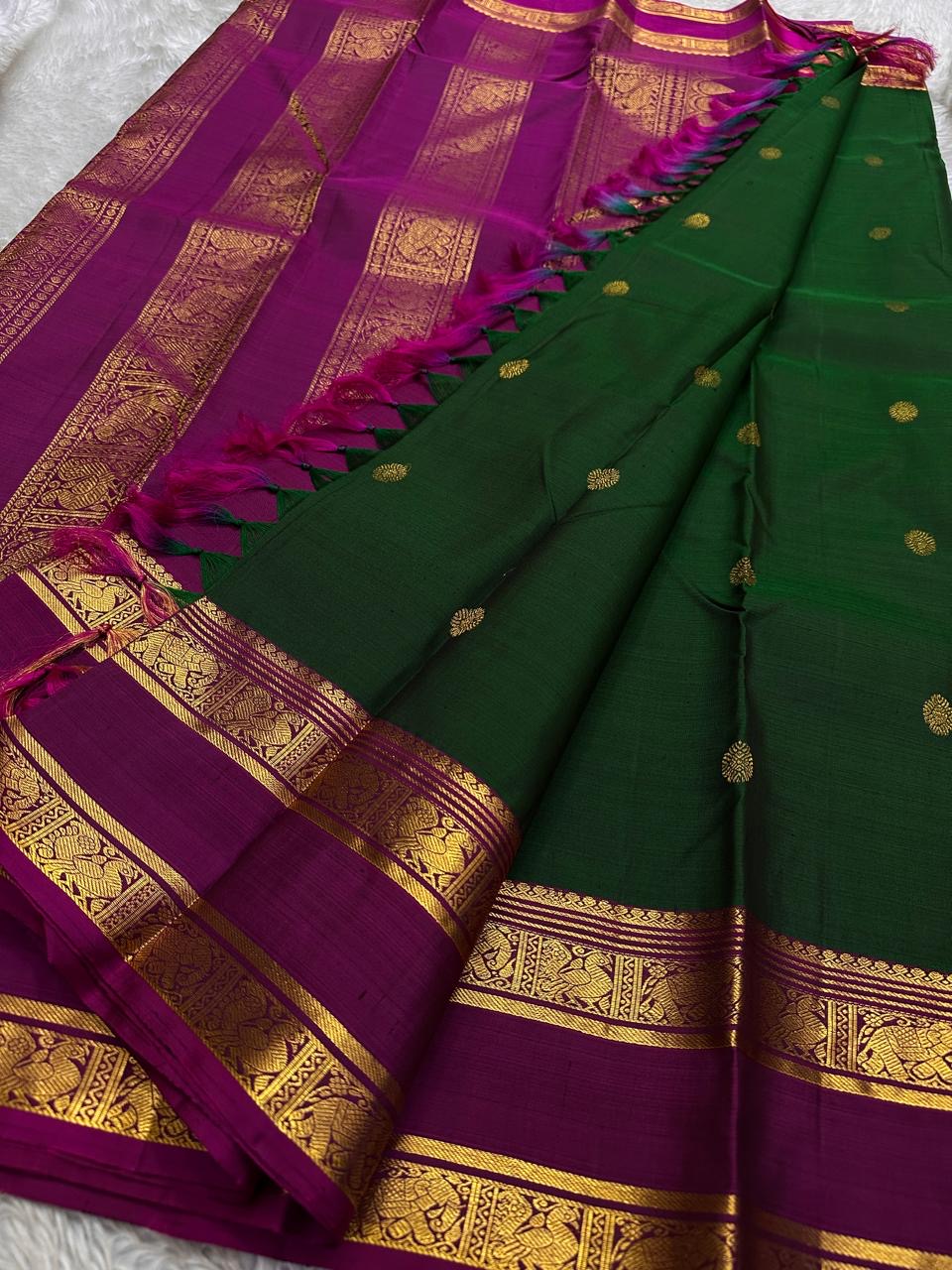Full saree view with emerald green body, magenta pallu and gold zari borders with tassels