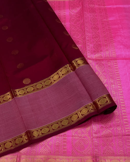 Cherry Red Silk Cotton Saree  
Raspberry Pink Rettapet Border  
Pavun Coin Butta All Over  
Grand Floral & Rudraksham Pallu
