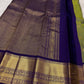 Olive green Kancheepuram Vairaoosi silk saree folded, showing purple border detail
