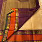 Pallu view of pure Kanchipuram silk saree showing deep maroon purple zari woven pallu field with gold patterning and rust orange border accents