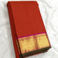 Radiant red orange pure silk Kanjivaram saree with raspberry pink zari border – full drape view