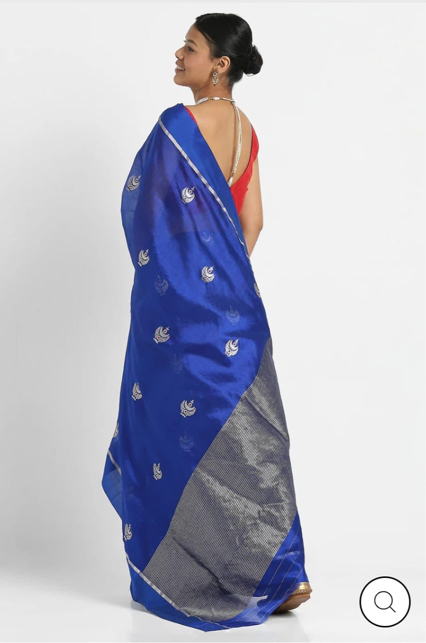 Close-up of the tiny red accents within the silver-toned woven motifs on a Royal Blue Chanderi saree