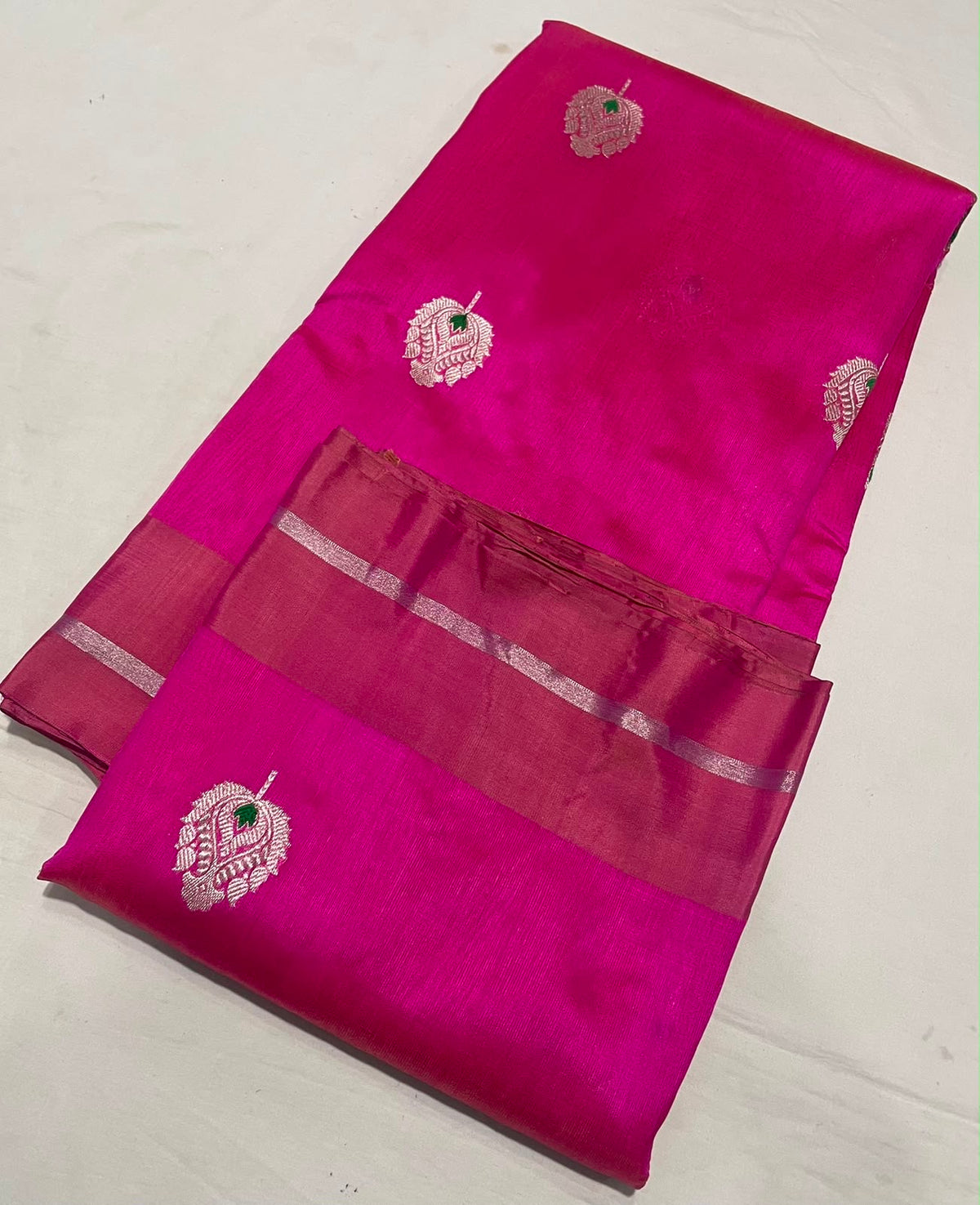 Close view of Rani Pink Pattu Silk Chanderi with silver zari paisley motifs, green meenakari and silver zari pallu