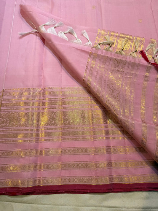 Detailed gold zari elephant and peacock motifs on the blush pink Varisaipet self border