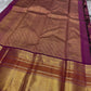 Full pallu of magenta Kanchipuram silk saree with intricate allover gold zari design and broad border