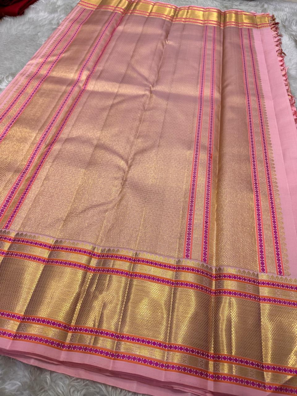 Full layout of blush pink Kanchipuram silk saree pallu with dense gold zari weaving and patterned borders – Idam Living
