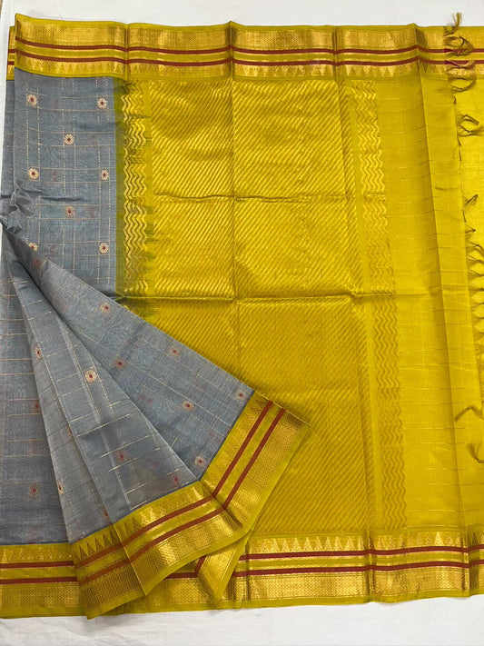 Silk Cotton Saree with Grey Body & Yellow Zari Pallu
Steel grey body adorned with floral buttas.
Yellow contrast border with twin red stripes.
Golden zari weaving adds festive richness.
A radiant yellow pallu with heritage patterns.
