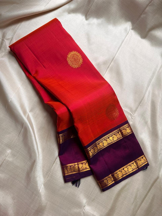 Bright marigold orange with purple rettapet border Mayil motif and beautiful mandala kamalam butta all over the pure silk Kanchipuram saree
