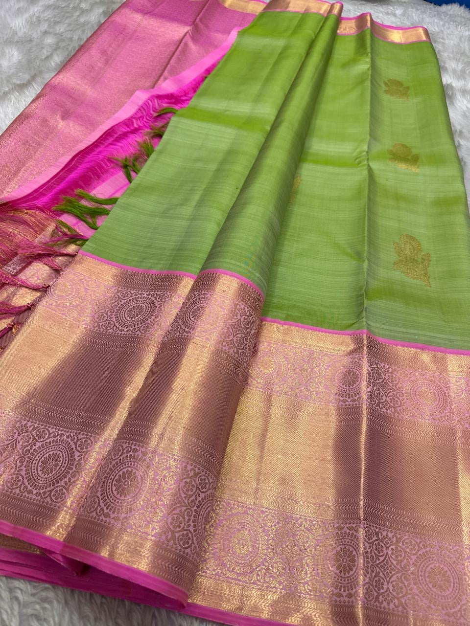 Spring green silk saree with pink zari woven border, gold buttas and contrast pallu, full view