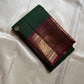 Pachai Butta – Pure Kanchipuram Silk Saree
Emerald silk scattered with radiant buttas.
A wine korvai border rich in gaja artistry.
Floral medallions glow in antique-gold zari.

Silk Mark Certified, delivery in 2 weeks