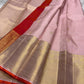 Rose Twilight — Kanchipuram Pure Silk

 Soft blush-pink (gulabi) body with gold floral buttas

Rosé-gold zari borders with floral vines & creepers

Vermilion-orange contrast pallu with kaddi & brocade panels

Silk Mark Certified | Free Shipping within USA