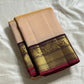 Sandhya 🌅 – Sun-Kissed Beige Kanchipuram Silk Saree with Subtle Vairaoosi Gold Filament ✨, Deep Purple Peacock Diamond-Pettu Zari Border 🦚, Deep Maroon Selvedge, and Zari-Embellished Pallu with Arai Maadam & Khalasam Motifs 🌿💛