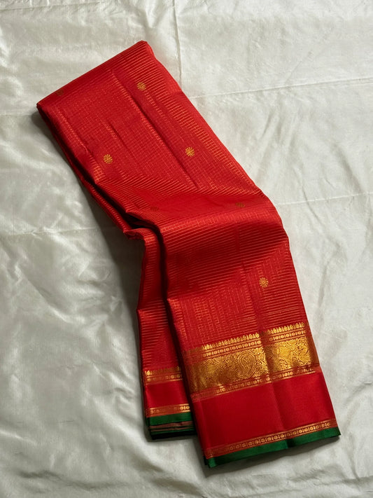 Hema – Bright Red Pure Silk Saree with Golden Zari Kattam
Featuring Baby Buttas and a Green Selvedge for a Subtle Contrast
Red Borders with Vanasringaram & Kamalam Motifs in Fine Zari
(available on pre-order 6 weeks)