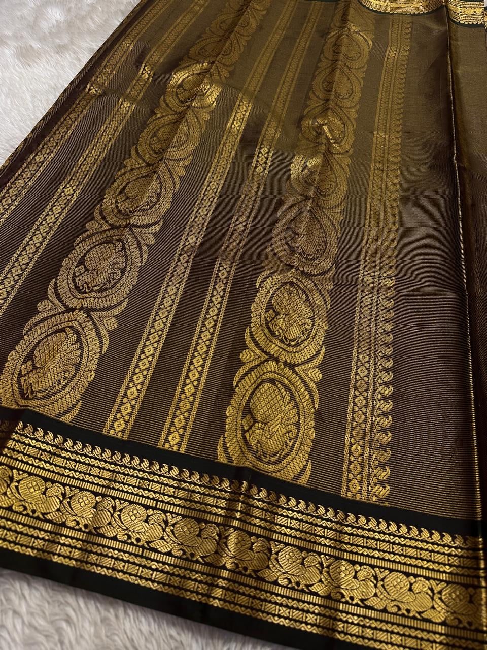 Kohl Swarna — silk mark certified lightweight saree 
Deep kohl brown body with fine pinstripes and gold rosette buttas, framed by antique-gold zari borders and grand paisley brocade pallu• free shipping eithin usa  two weeks