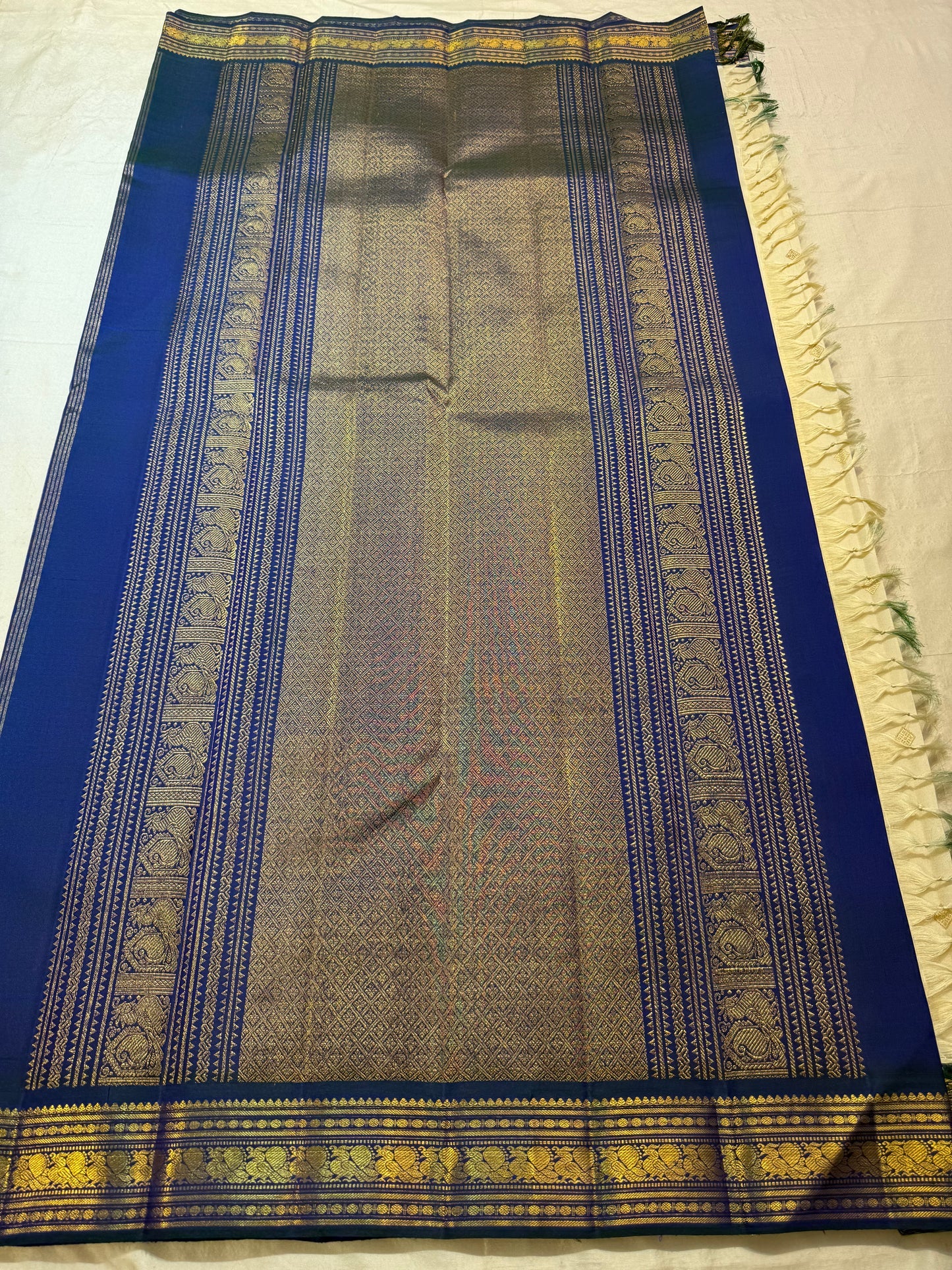 Warm Ivory Handwoven Pure Silk Kanjivaram Korvai saree draped, showing the Mayil Kazhuthu blue-green border and richly woven pallu.