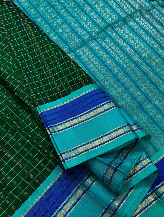 Lakshadweepam  kattam checks in bottle green ,  blue and teal  zari work with kamalam butta border