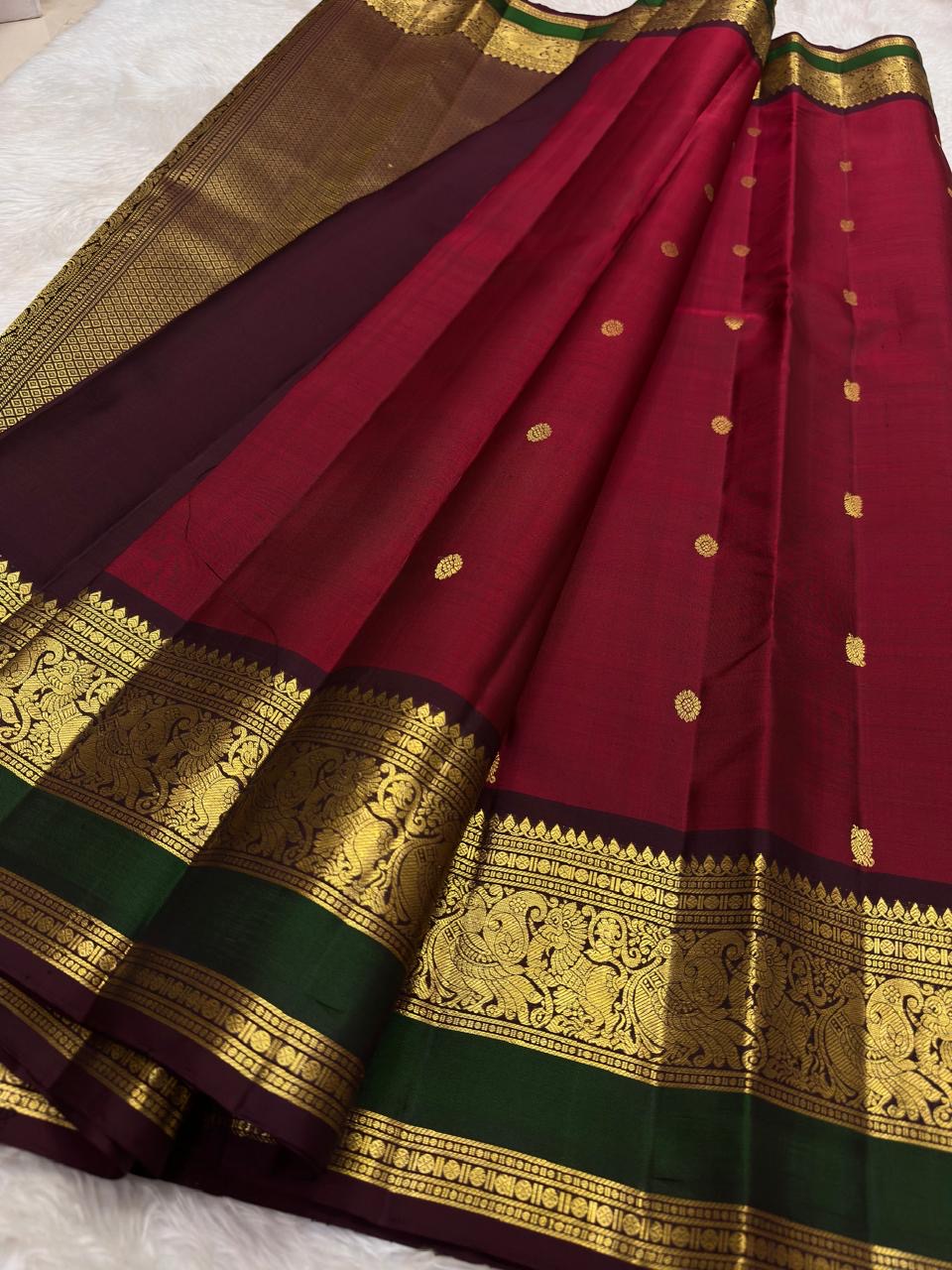 Large-scale vanasringaram gold zari motifs on arakku red Kanjipuram saree border — Idam Living