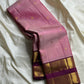 Rose Mist Zari Kattam — Kanchipuram Pure Silk

Blush rose-pink body with micro kattam (checks) in zari & scattered soorya-chakram buttas

Contrast mulberry purple korvai borders with rich gold zari detailing

Free shipping within USA silk mark certified