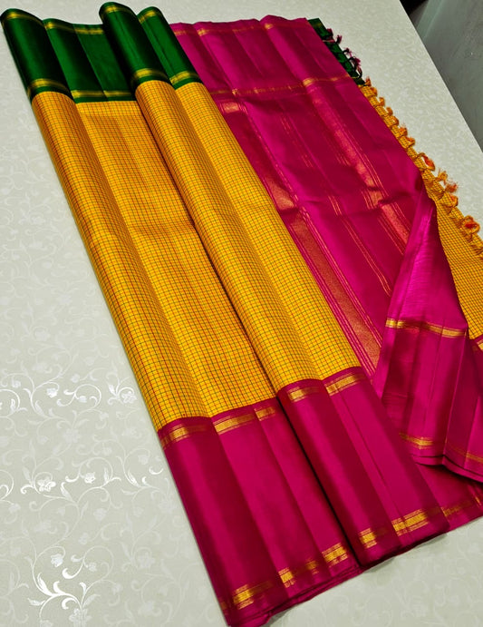 Suvarna Kattam ✨ – Pure Kanchipuram Silk Saree
Golden Mustard Body with Intricate Kattam Checks
Vibrant Magenta Pink Border with Zari Detailing
Emerald Green Selvedge Adding Striking Contrast

Silk Mark Certified, delivery in 2 weeks