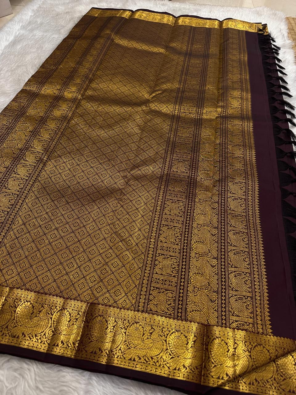Aubergine brown Pure Silk Kanjivaram saree with intricate Annapakshi border and gold zari buttas