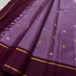 Ilam  Vadamalli Chakram — Kanchipuram Pure Silk

Pastel lilac–mauve body with gold & silver chakram buttas

Deep plum contrast border with twin kaddi zari lines

Plum pallu with elegant vertical zari stripes; lilac tassels

Silk Mark Certified •