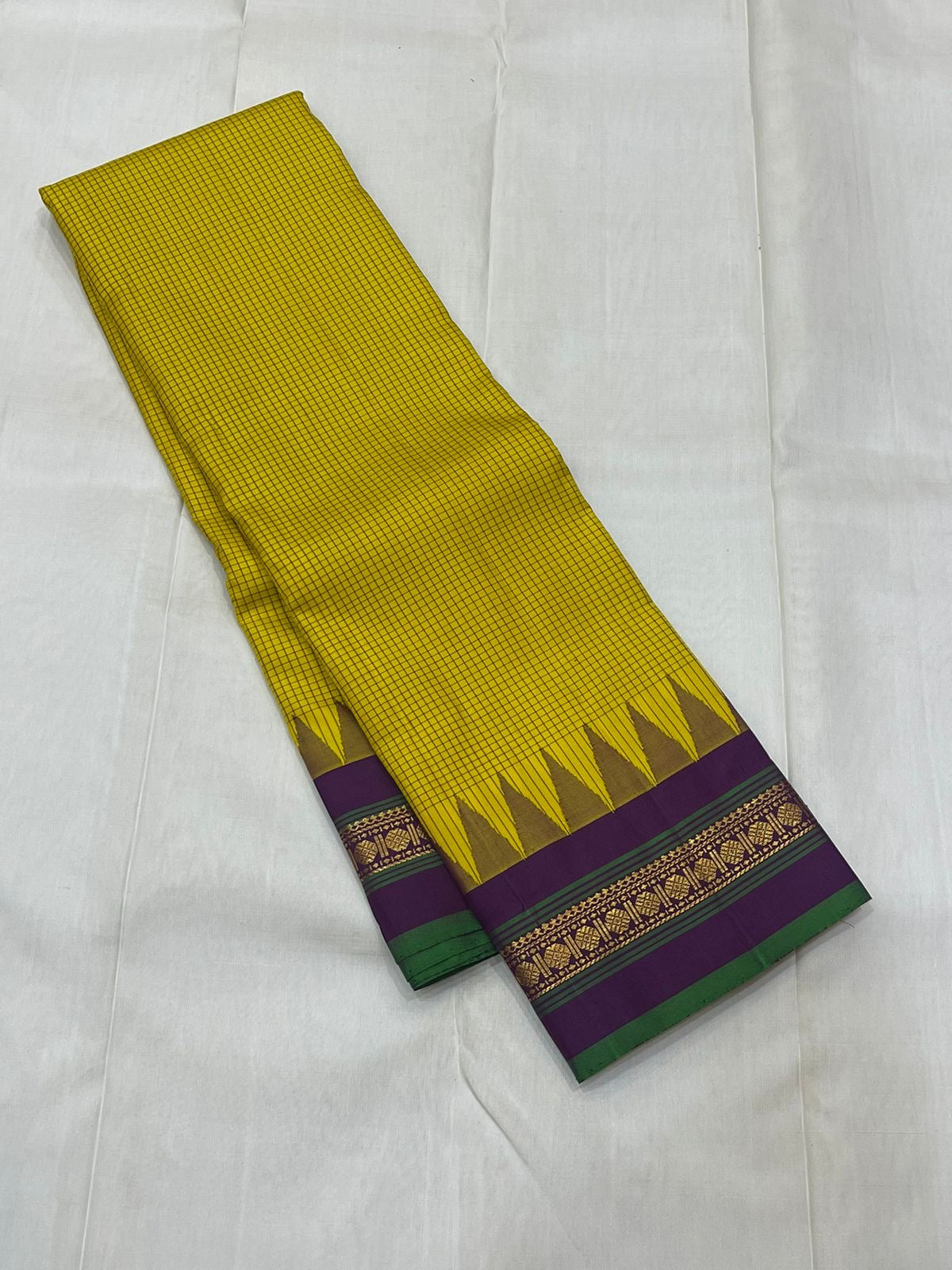 Ochre Turmeric Kattam

Pure Kanchipuram Silk Saree – Ochre Yellow Body with Fine Kattam Checks

Contrast Korvai Borders with Temple Serrations & Floral Zari

Grand Zari Brocade Pallu with Hand-Knotted Tassels

Silk Mark Certified ✅ |ships in 2 weeks