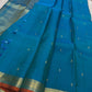 Peacock Teal Ilai Butta – serene teal body with copper-gold zari borders

Pure Kanchipuram silk • dainty leaf (ilai) buttas scattered across the body
Rich teal zari pallu

Silk Mark Certified | Fall & Pico Done | Blouse Stitching Available ($30)