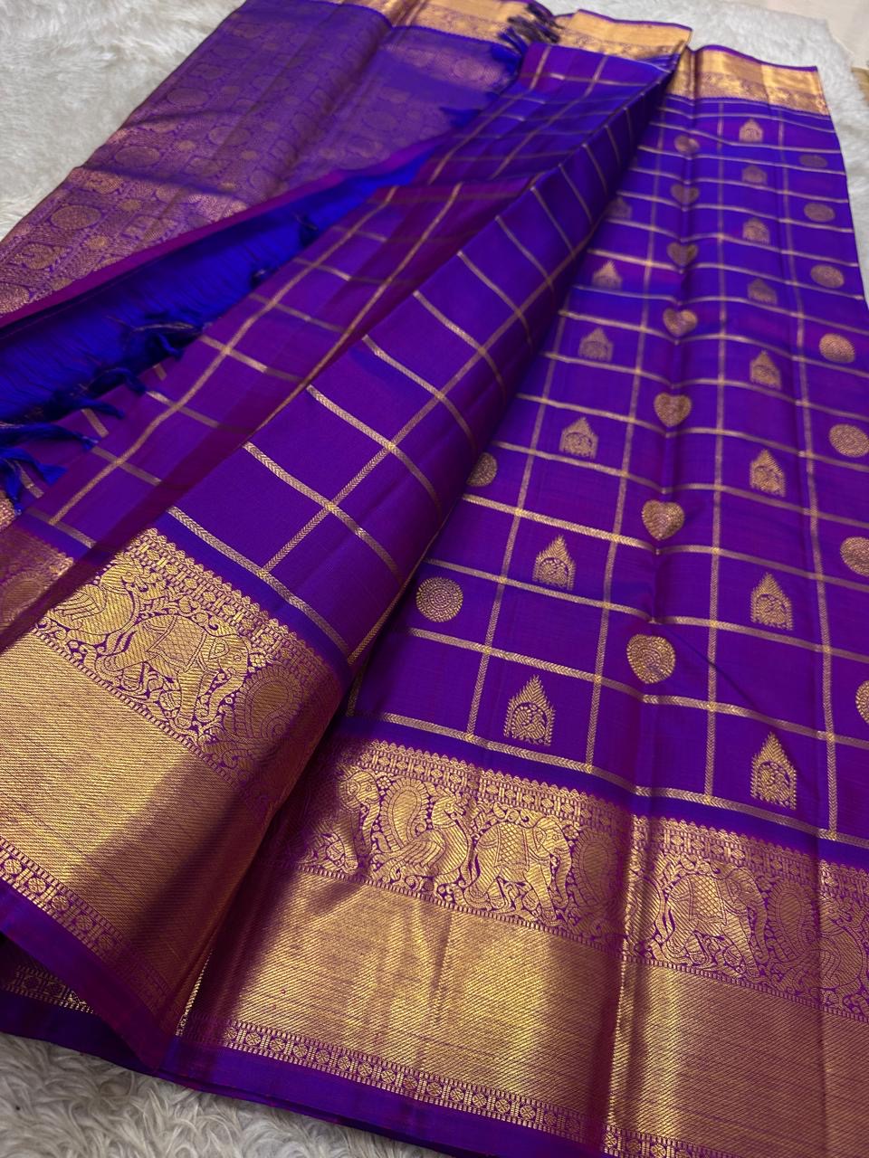 Leelavati Kattam
Amethyst Purple Kanchipuram Silk Saree
Zari-Woven Checks with Elephant Procession Border