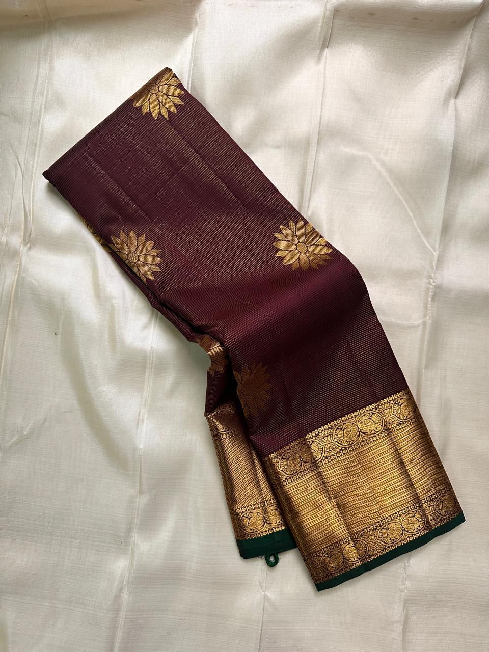 Bronze Lotus Vairaoosi
Coffee-Deep Kanchipuram Silk Saree
Grand Zari Borders • Lotus Butta Elegance