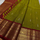 Golden Emerald Gleam ✨ – Pure Kanchipuram Silk Saree
Parrot Green & Turmeric Shot with Gold & Silver Leaf Buttas 🌿
Crimson Red Korvai Border with Temple Peaks  ❤️
Grand Crimson Pallu 🌟

Silk Mark Certified, delivery in 2 weeks