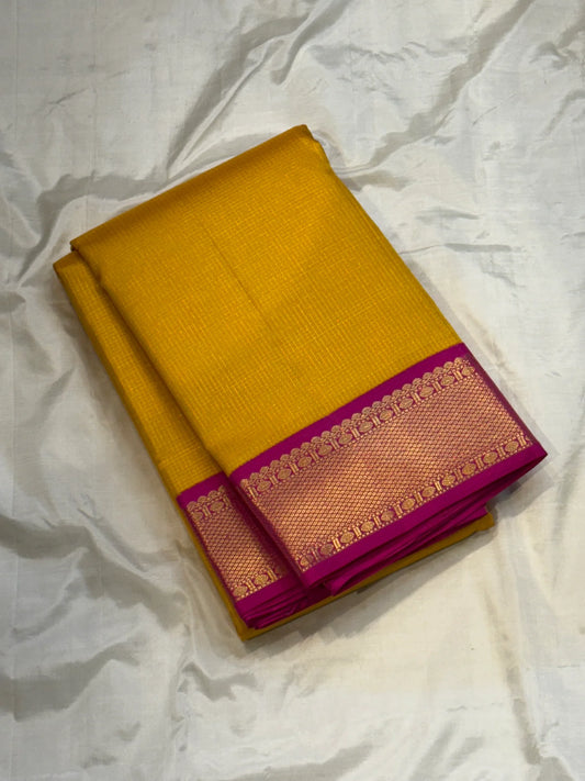 Ambar Rani — Pure Kanchipuram Silk Saree
Amber yellow oosi-kattam checks with contrast rani-pink korvai border and grand zari brocade pallu.
Silk Mark Certified • Free Shipping within USA • Ships in Two Weeks ✅