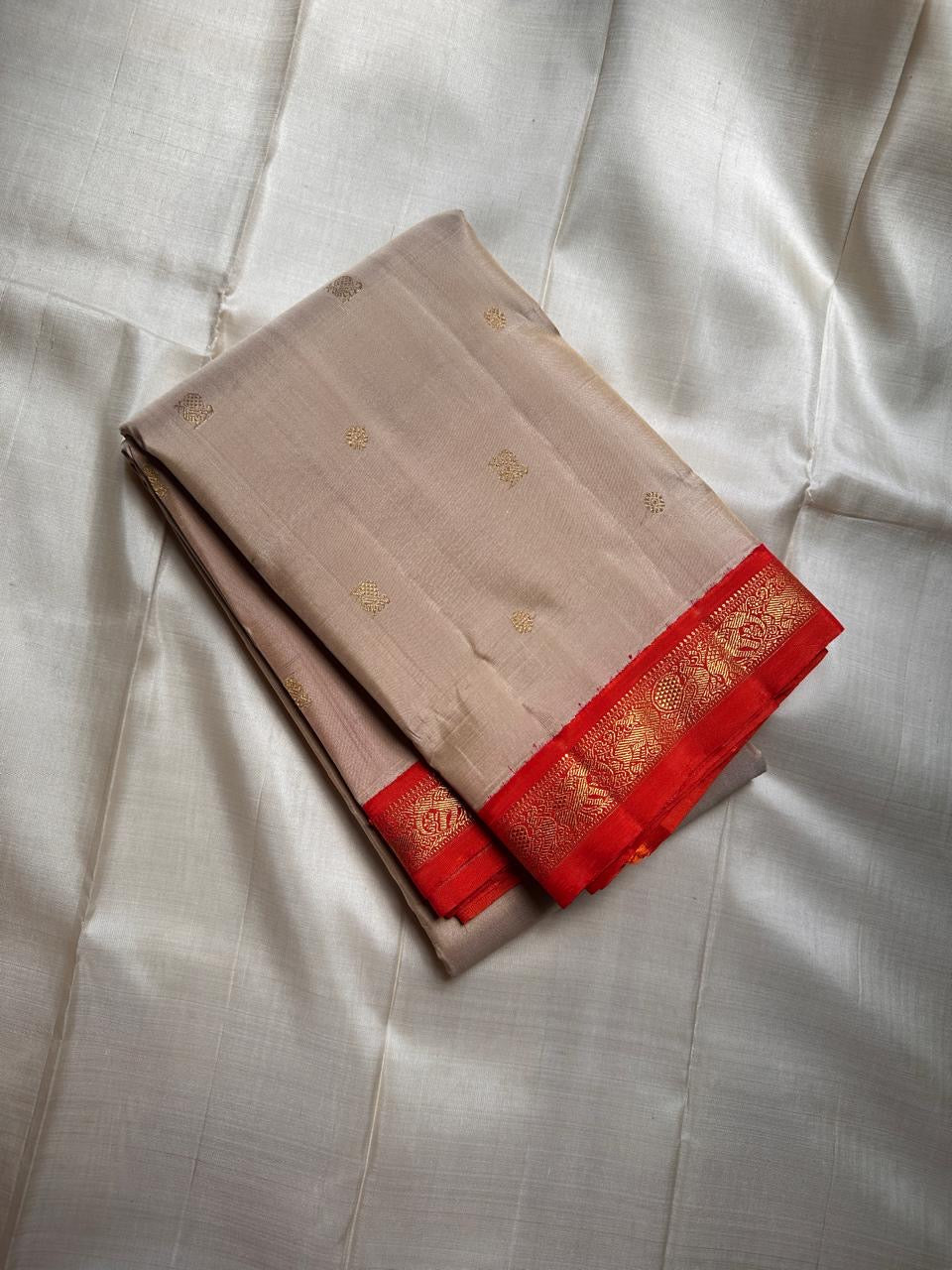 Amber Shubhra Butta — Pure Kanchipuram Silk Saree
Ivory body with golden zari buttas and vibrant amber-orange pallu
Pure 3gm zari • Silk Mark Certified • Free Shipping within USA