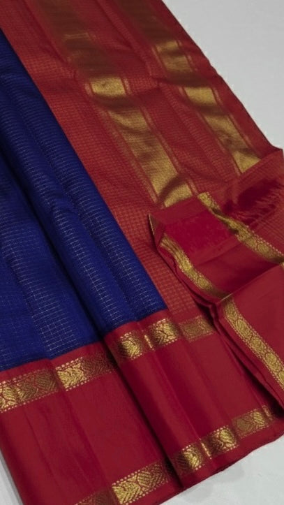 💎 Sapphire Rouge Oosi Kattam — Pure Kanchipuram Silk Saree
Royal sapphire-blue body with fine oosi-kattam checks and contrast rouge-red borders in antique-gold zari
Silk Mark Certified • Free Shipping within USA • Ships in Two Weeks •
