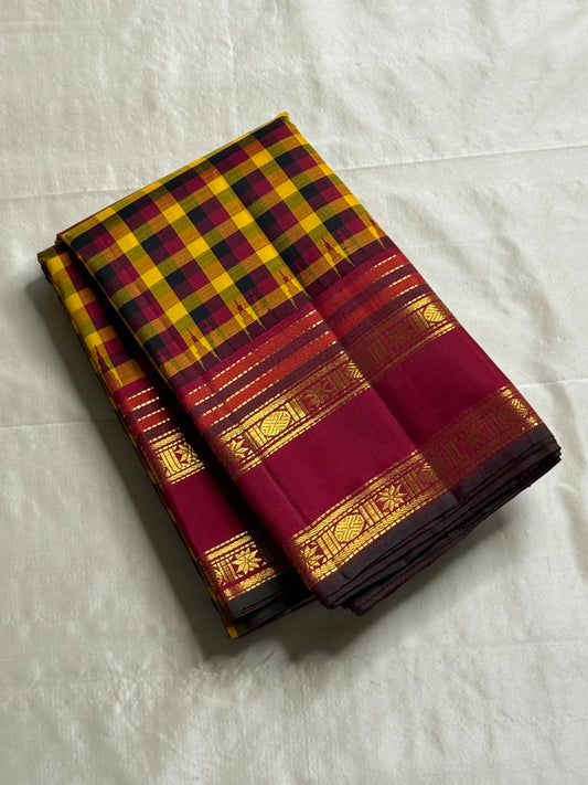 Manjal Maroon Kattam – Pure Kanchipuram Silk Saree
Mustard & Maroon Body with Traditional Multi-Color Checks
Korvai Borders with Floral-Star Zari & Temple Tips
Grand Maroon Pallu with Gold Zari Stripes & Tassels
Silk Mark Certified | ships in 2 weeks