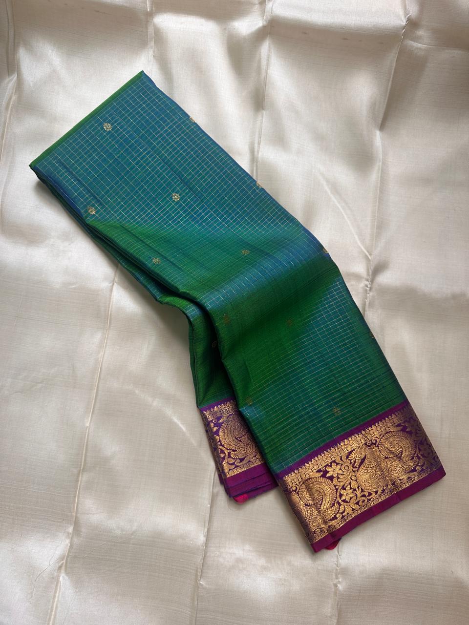 Vrindavan Meadow
Peacock Vairaoosi in Emerald & Lagoon Blue
Pure Kanchipuram Silk · Zari-Woven Border Grandeur