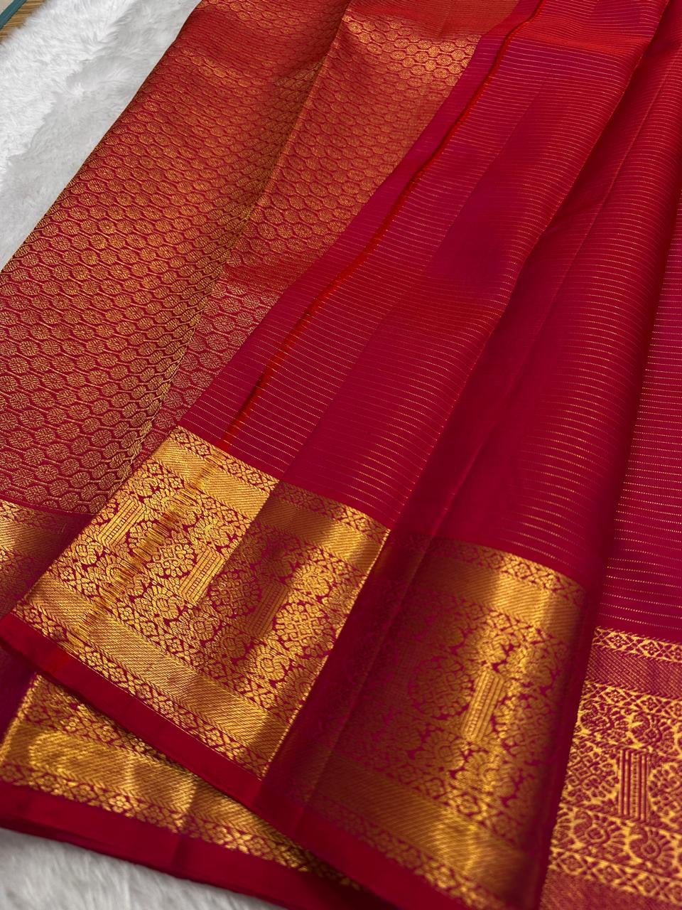 Traditional antique gold zari border on radiant pink Kanchipuram silk saree