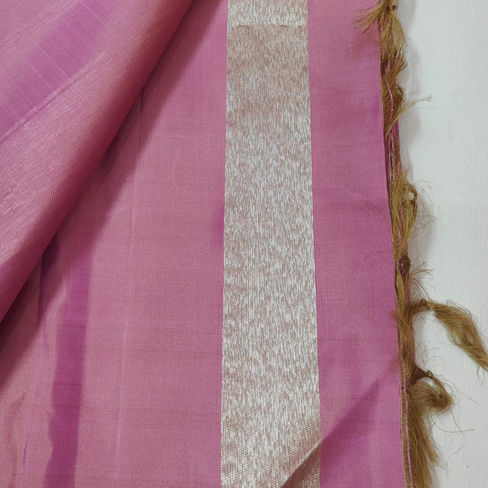 Close view of classic gold zari border on delicate pink Ettukol Kanchipuram silk saree