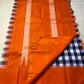 Indigo–Tangerine Checkmate — Pure Silk Kanchipuram
Bold indigo–lilac–white buffalo checks with ash accents ✨
Vibrant tangerine korvai border with temple (reku) teeth 🌸
Solid tangerine pallu with fine thread stripes & tassels 🪔
Silk Mark Certified •