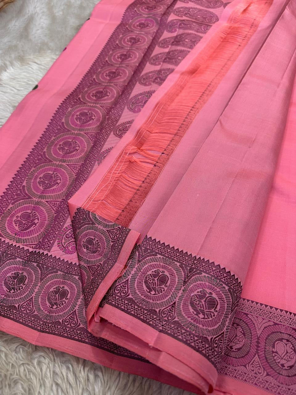 Close view of dark woven border with circular medallions on a pink pure Kanchipuram silk saree, available in the USA